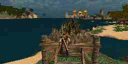 The Avatar stands on a dock near the ocean, and in the distance is a town on a distant shore.