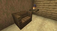 A Minecraft game screenshot in which we see a brown room in a cabin. The chair in the middle is made of stairs with slim vertical spruce trapdoors against it, forming makeshit armrests.