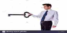 A man in office attire holding a giant key.