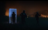 Three soldiers carrying guns walk out of a rectangular gelatinous glowing portal through a forest at night. Portal is blue-colored.